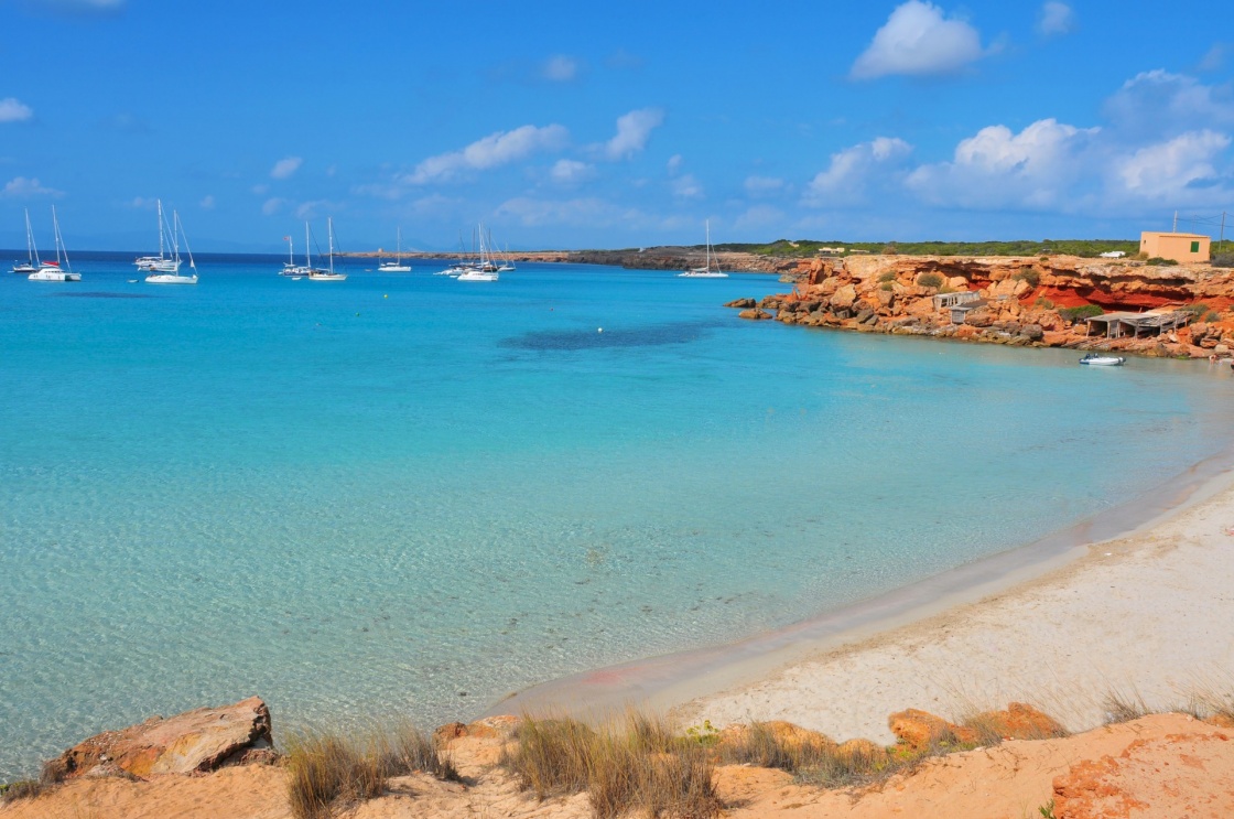 view of Cala Saona Beach, the mediterranean Sea and the typical slipways and fishermen huts, called barraques, in Formentera, Balearic Islands, Spain